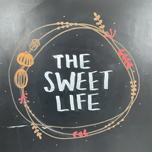 a chalkboard sign for hours