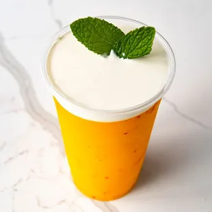 a cup of yogurt with a mint leaf on top