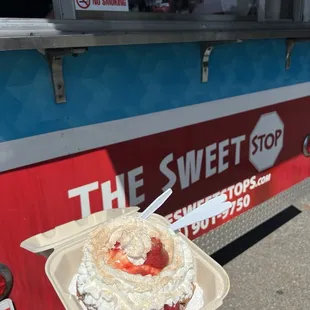 Funnel cake with ice cream, strawberries, whipped cream and cinnamon sugar