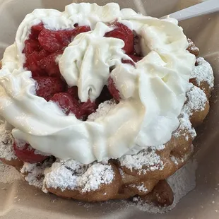Funnel cake with strawberries and whipped cream