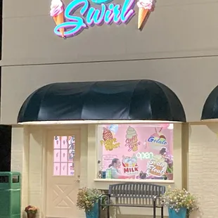 a storefront with a bench in front of it