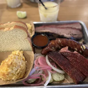 3 meat plate with brisket ribs and jalapeño sausage with corn casserole on the side.