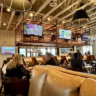 people sitting at tables in a restaurant