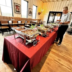 a man standing in front of a buffet table
