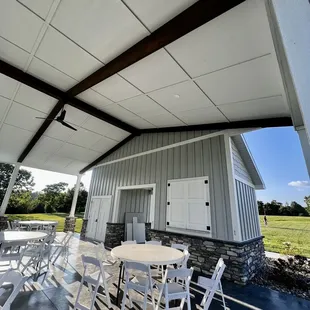 a patio with tables and chairs