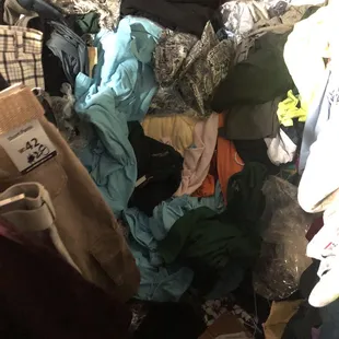 Whoa stack and stacks of shirts etc all over *1/21/2021