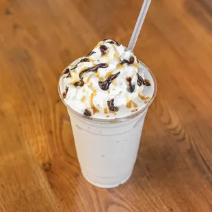 a milkshake topped with whipped cream and chocolate chips