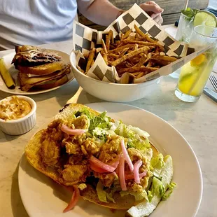 a plate of food and a bowl of fries