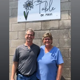 Owners Barrett and Kris Grove by the sign at the back entrance.