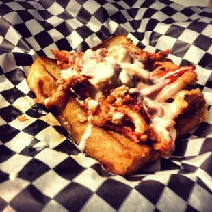 The Open Face Lobster Taco on Garlic Texas Toast smothered in Cheese Sauce