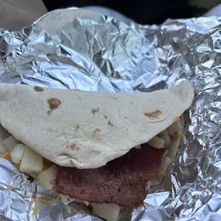 a hand holding a piece of food