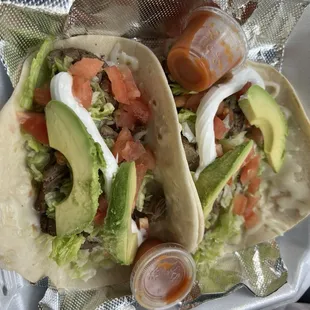 Fiesta Tacos: Beef Fajitas, cheese, lettuce, tomato, avocado, &amp; sour cream.
