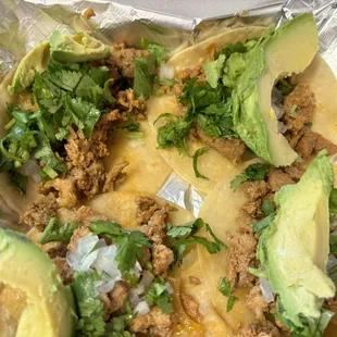 Al pastor mini tacos with cilantro and avocado