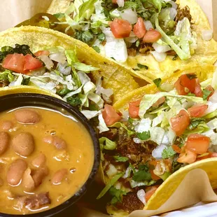 three tacos and a side of salsa