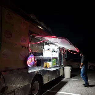 a man standing in front of a food truck