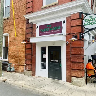 a man sitting outside a restaurant