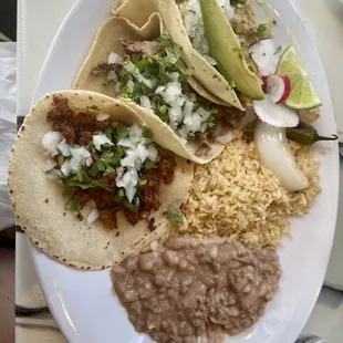 Shrimp taco, Carne asada taco, and Al pastor taco with a side of rice and beans