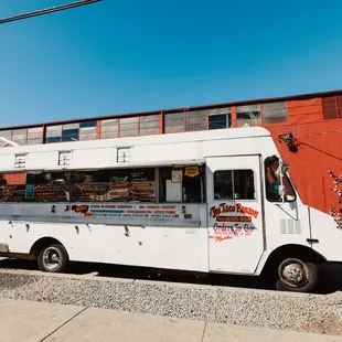a white food truck parked in front of a building