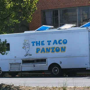a taco truck parked on the side of the road