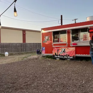 a man standing in front of a food truck