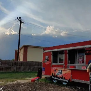 people ordering food from a red food truck