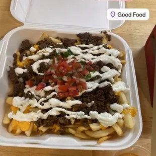 Absolutely Scrumptious Asada Fries that has nacho cheese &amp; sour cream topped off with some pico de gallo.