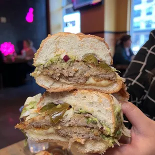 a person holding a sandwich