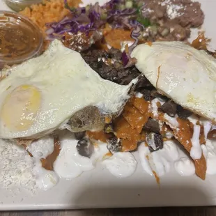 Carne Asada Chilaquiles with sunny side up eggs.