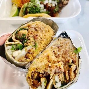 a person holding a burrito