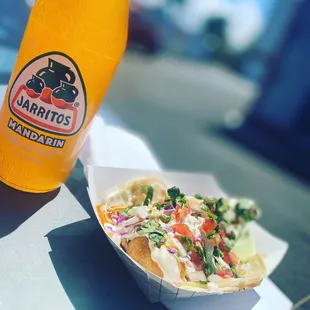 a bottle of juice and a taco