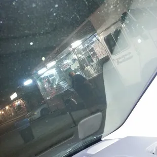 the reflection of a man in the windshield