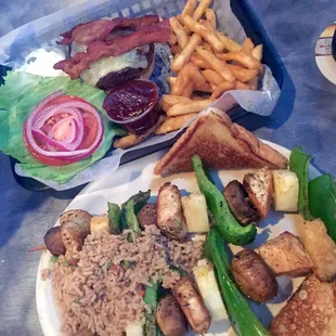Stuffed burger with jalapeños and pepperjack and added bacon and fries. Along with chicken kabobs and rice.