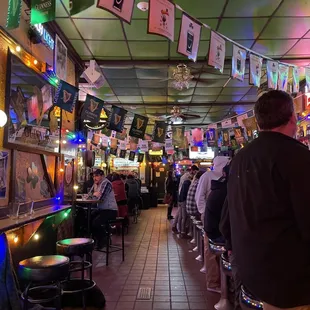 people sitting at tables in a bar