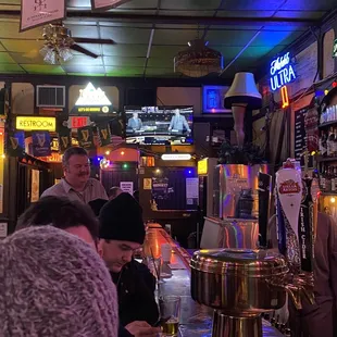 a group of people sitting at a bar