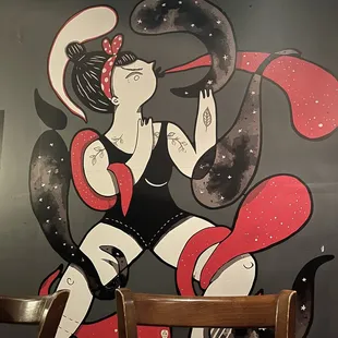 a woman sitting on a chair in a restaurant