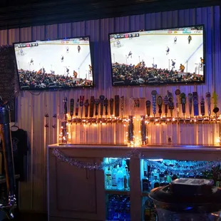 two televisions and a bar