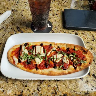 a plate of pizza and a drink