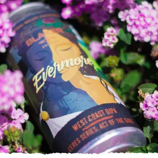 a can of beer surrounded by flowers