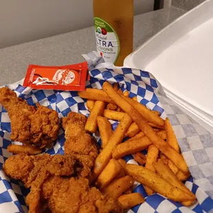 a basket of fried chicken and french fries