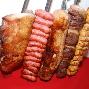 a variety of meats on skewers