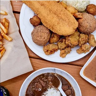 a bowl of gravy and a plate of fried chicken