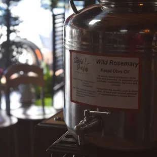 a glass of wine next to a large metal pot