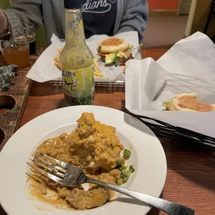  plate of food and a bottle of beer