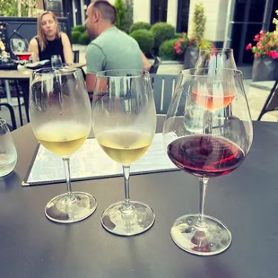 three glasses of wine on a table
