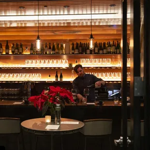 a man pouring a glass of wine
