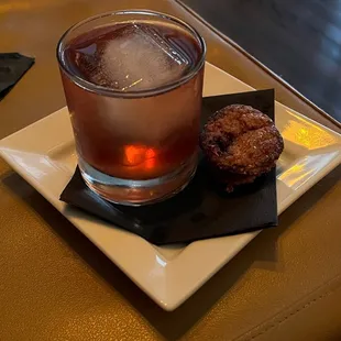 a drink and a donut on a plate