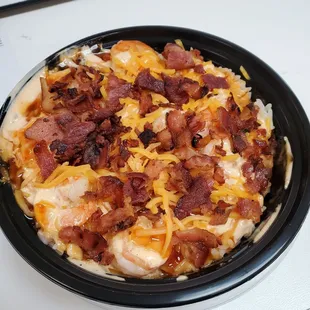 White rice bowl with shrimp, bacon and cheese.