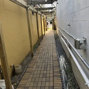 Side alley to the shop and parking in the back