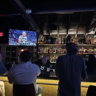 a group of people sitting at a bar