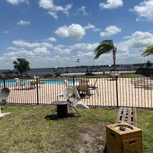 a dog house with a pool in the background